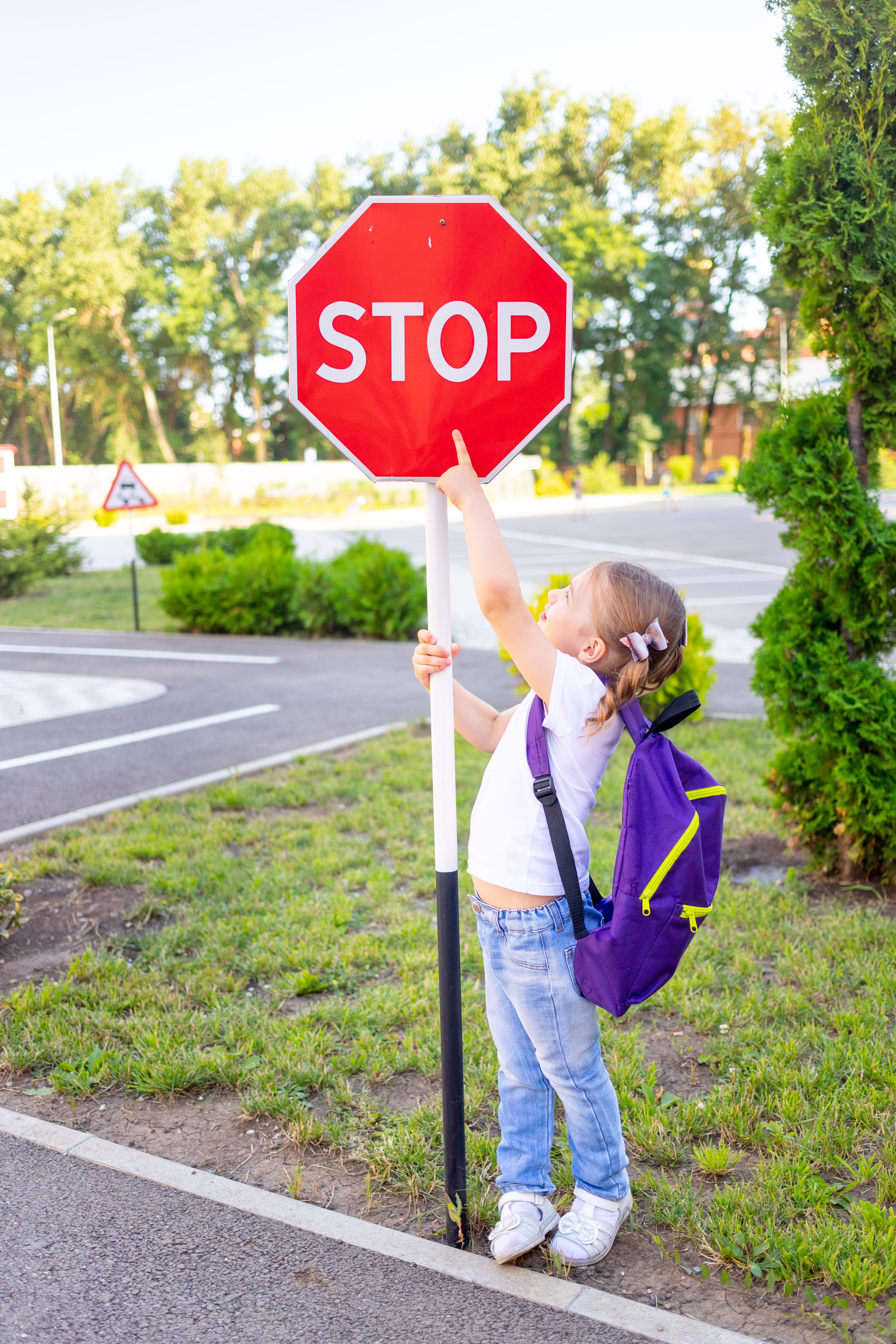 preschooler pointing at stop sign